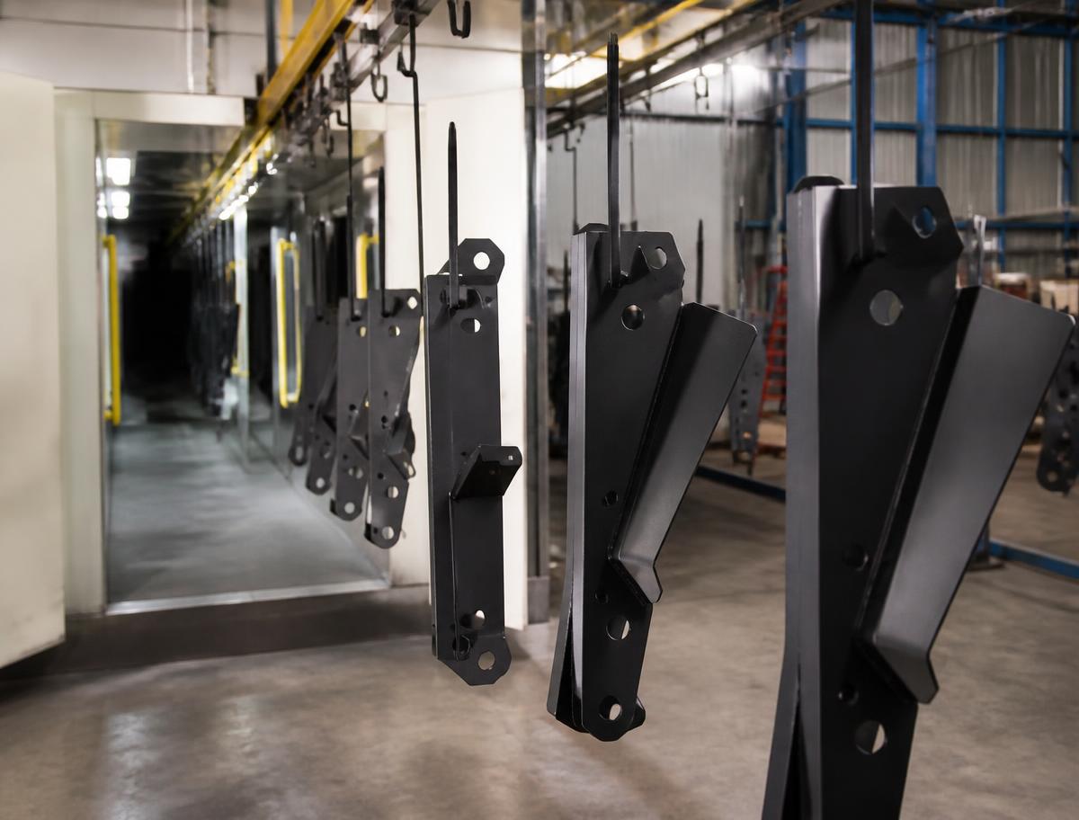 Powder-coated steel components on a coating line